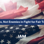 Canadian flag on top and United States flag on bottom laying down scrunched together with a blue banner in the middle saying Allies. Not Enemies in Fight for Fair Trade.